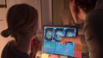 Emily Jacobs and Caitlin Taylor look at images of the brain on a computer.